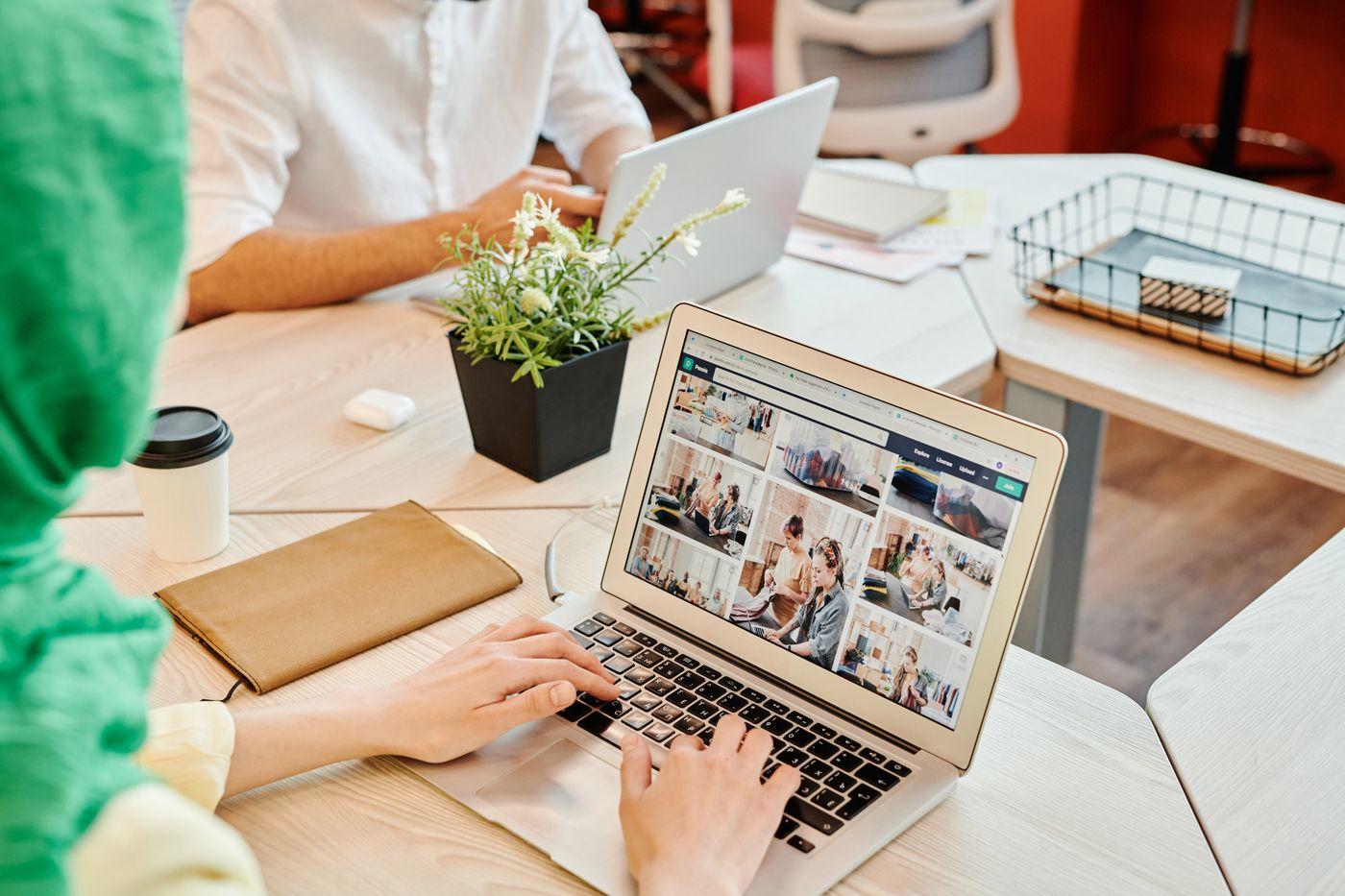 People using laptops in a shared workspace